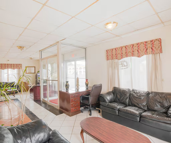 Lobby waiting area with sofas and glass cabin