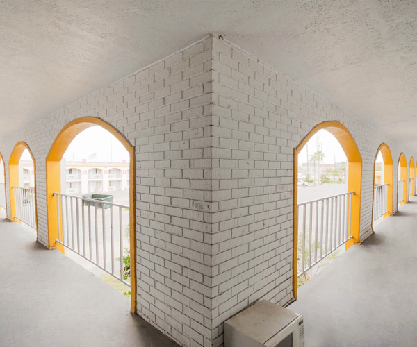 Outdoor hotel corridor with arches